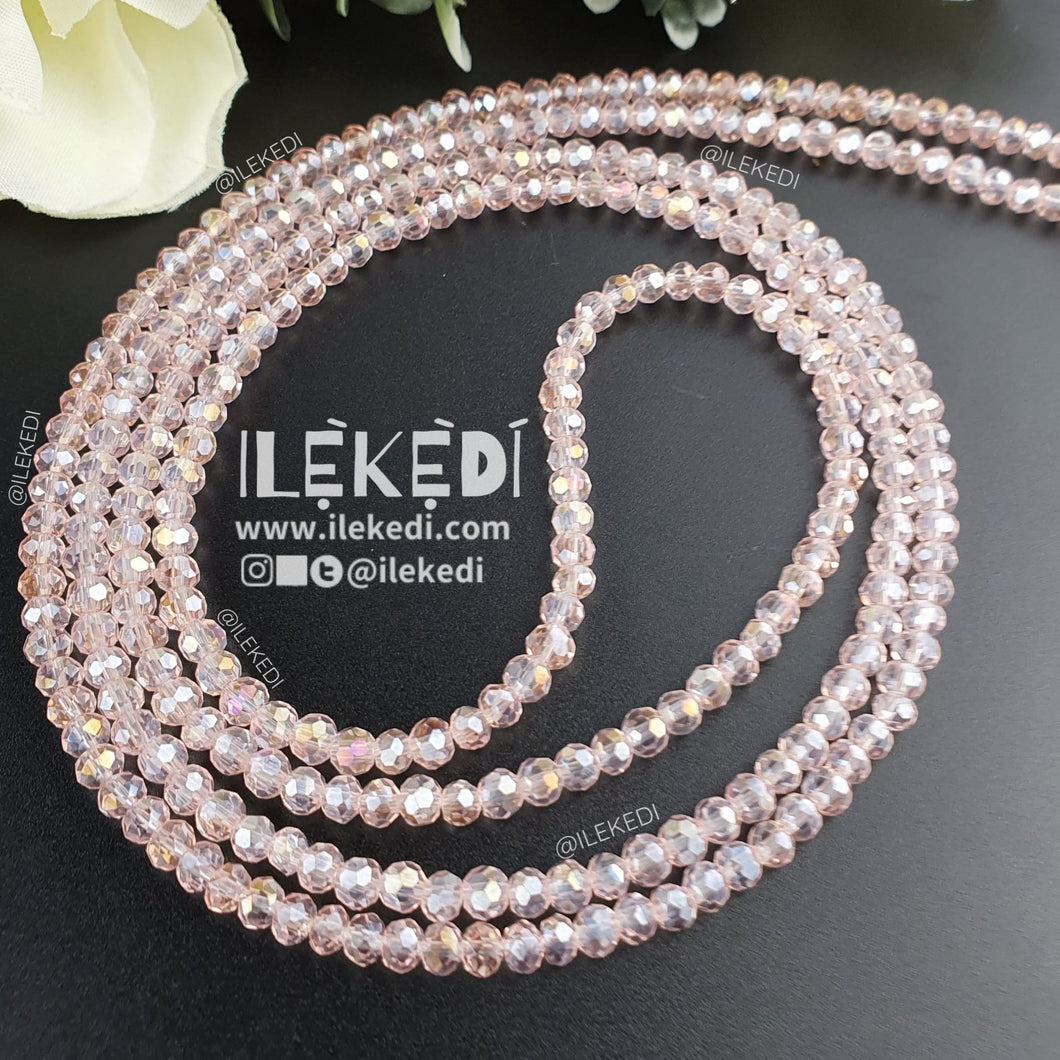 Ilekedi Rose Water Pink Clear Transparent Waistbeads Wrapped in circle on a black backdrop